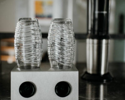 Stainless steel bottle holder for glass carafes